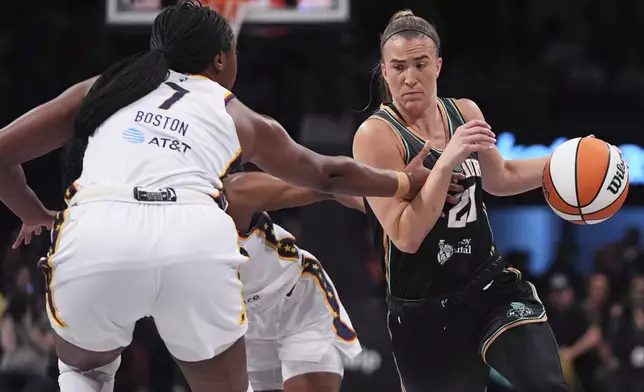 New York Liberty's Sabrina Ionescu, right, drives past Indiana Fever's Aliyah Boston during the first half of a WNBA basketball game Wednesday, July 16, 2025, in New York. (AP Photo/Frank Franklin II)