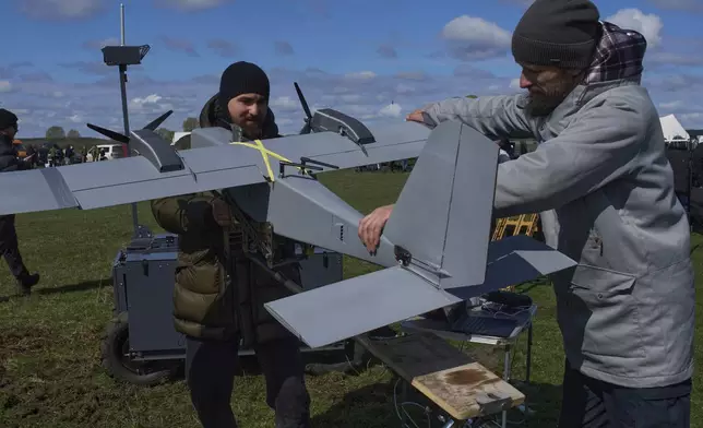 FILE - A manufacturer demonstrates a Ukrainian made drone at a Ukraine Defense Innovations exhibition for military clients on an undisclosed location in Ukraine, Friday, April 11, 2025. (AP Photo/Efrem Lukatsky, File)