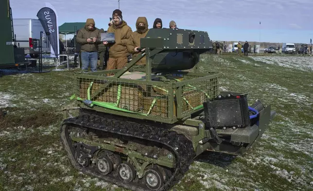 FILE - A manufacturer demonstrates a Ukrainian made unmanned ground vehicle at a Ukraine Defense Innovations exhibition for military clients on an undisclosed location in Ukraine, Friday, April 11, 2025. (AP Photo/Efrem Lukatsky, File)