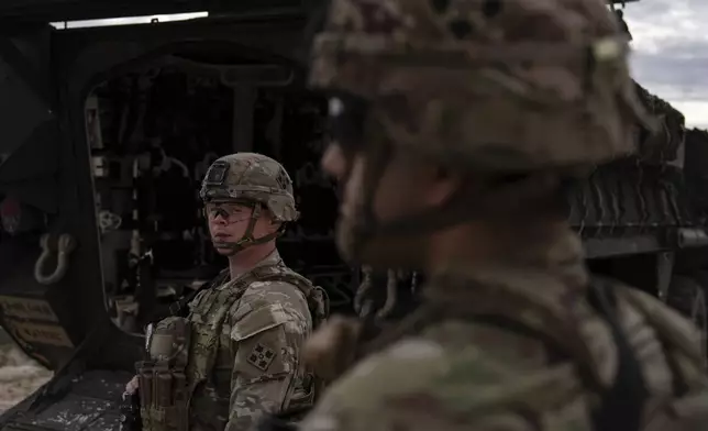 U.S Army Sgt. Brenden Richards monitors the area while standing next to a Stryker combat vehicle Wednesday, July 23, 2025, in Sunland Park, N.M. (AP Photo/Jae C. Hong)