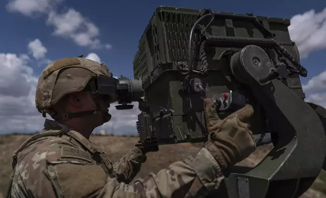 U.S. Army Spc. Jerimiah Starcher demonstrates the Long Range Advanced Scout Surveillance System on a Stryker combat vehicle in Nogales, Ariz., Tuesday, July 22, 2025. (AP Photo/Jae C. Hong)