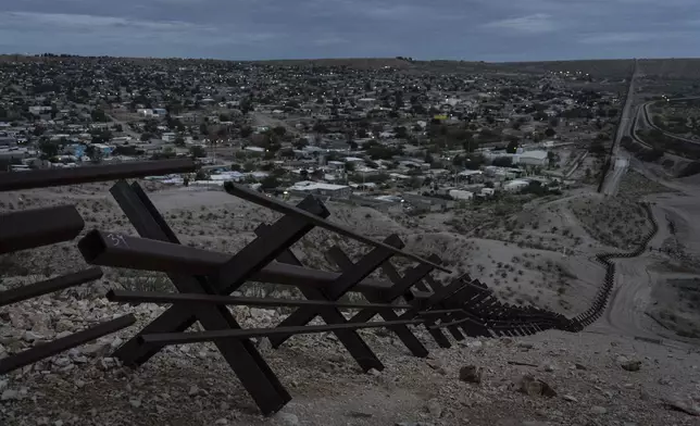 Barriers form part of the U.S.-Mexico border fence as they run along mountainous terrain overlooking Mexico's Ciudad Juárez on Wednesday, July 23, 2025, in Sunland Park, N.M. (AP Photo/Jae C. Hong)