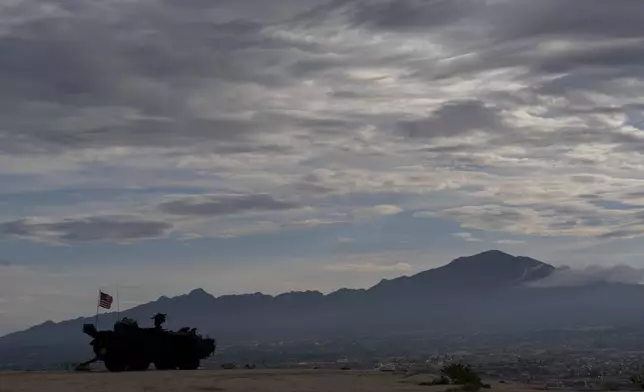 A Stryker combat vehicle sits atop a hill overlooking the U.S.-Mexico border fence in Sunland Park, N.M., Wednesday, July 23, 2025. (AP Photo/Jae C. Hong)