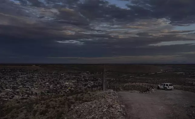 A U.S. Border Patrol vehicle is parked on a ridge overlooking the U.S.-Mexico border and Mexico's Ciudad Juárez in Sunland Park, N.M., Wednesday, July 23, 2025. (AP Photo/Jae C. Hong)