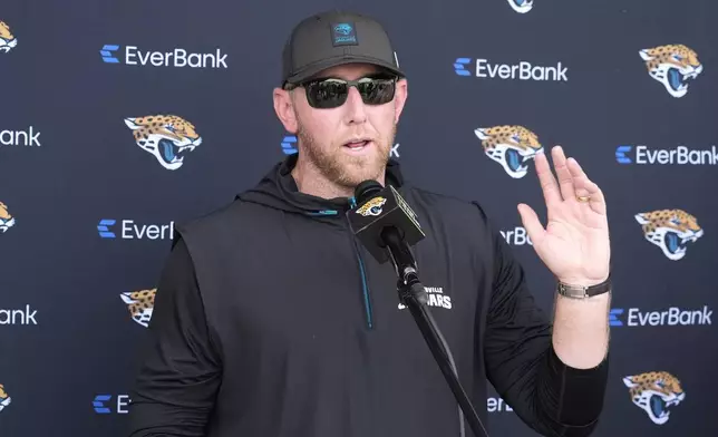Jacksonville Jaguars head coach Liam Coen talks with reporters after practice at the team's NFL football training camp, Wednesday, July 23, 2025, in Jacksonville, Fla. (AP Photo/John Raoux)