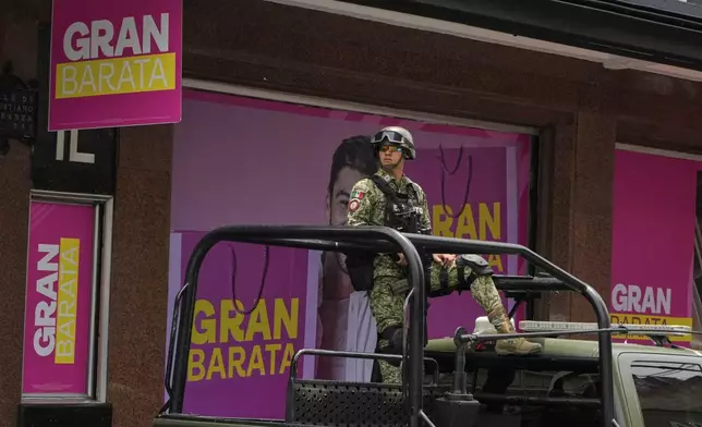 A soldier patrols a street in downtown Mexico City, Thursday, July 10, 2025. (AP Photo/Fernando Llano)
