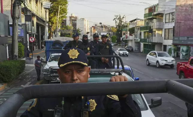 Mexico City police patrol a neighborhood in Mexico City, Wednesday, April 2, 2025. (AP Photo/Marco Ugarte)