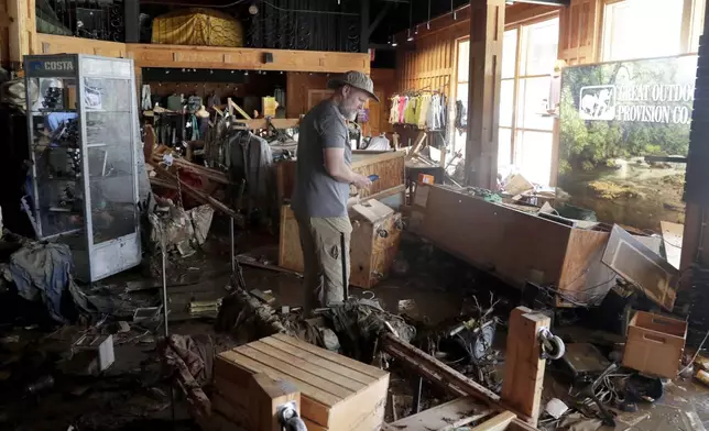 An employee surveys the damage at the Great Outdoor Provision Co. after it was flooded during tropical storm Chantal, Monday, July 7, 2025, in Chapel Hill, N.C. (AP Photo/Chris Seward)