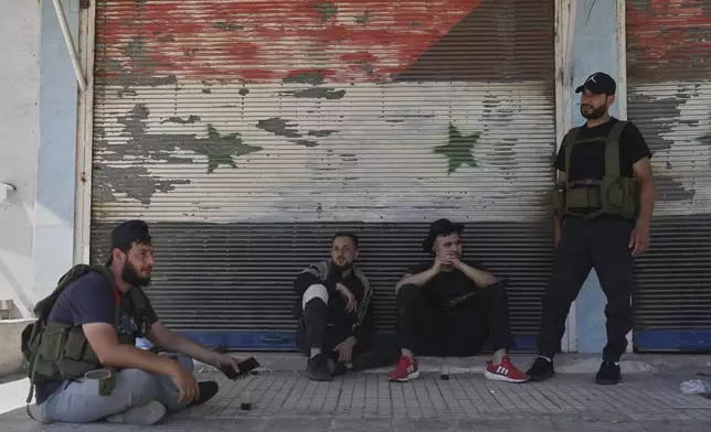 Bedouin fighters on a road in Ezraa village on the outskirts of Daraa city, after clashes erupted between the beduin clans and Druze militias in Sweida province, southern Syria, Friday, July 18, 2025. (AP Photo/Ghaith Alsayed)