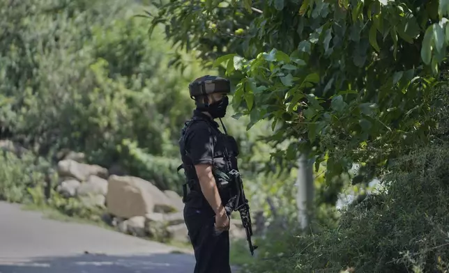 Jammu and Kashmir Special Operation Group (SOG) personnel guard near the site of a gun battle on the outskirts of Srinagar, Indian controlled Kashmir, Monday, July 28, 2025. (AP Photo/Mukhtar Khan)