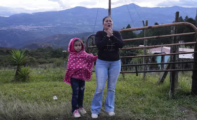 Gabriela Mora and her daughter react as her husband, Carlos Uzcátegui, a Venezuelan migrants deported months ago to El Salvador by the United States under an immigration crackdown, arrives home in Lobatera, Venezuela, Wednesday, July 23, 2025. (AP Photo/Ariana Cubillos)