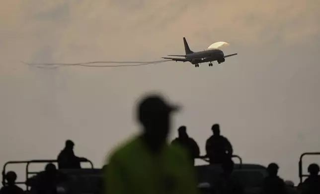 A plane carrying migrants deported months ago by the United States to El Salvador under the Trump administration's immigration crackdown lands at Simón Bolívar International Airport in Maiquetía, Venezuela, Friday, July 18, 2025. (AP Photo/Ariana Cubillos)