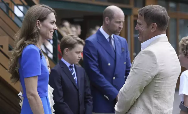 Britain's Prince William, second right, Kate, Princess of Wales, and Prince George meet Steve Backshall as they arrive to attend the men's singles final match between Italy's Jannik Sinner and Spain's Carlos Alcaraz at the Wimbledon Tennis Championships in London Sunday July 13, 2025. (Andrew Matthews/Pool via AP)