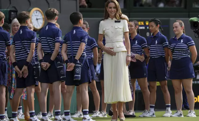 Kate, Princess of Wales speaks to ballboys and ballgirls as she participates in the presentation ceremony for the women's singles final at the Wimbledon Tennis Championships in London, Saturday, July 12, 2025. (AP Photo/Kin Cheung)