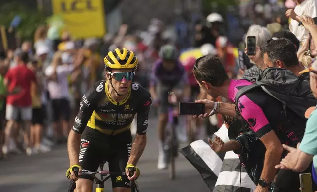 Stage winner Britain's Simon Yates climbs breakaway during the tenth stage of the Tour de France cycling race over 165.3 kilometers (102.7 miles) with start in Ennezat and finish in Le Mont-Dore Puy de Sancy, France, Monday, July 14, 2025. (AP Photo/Thibault Camus)