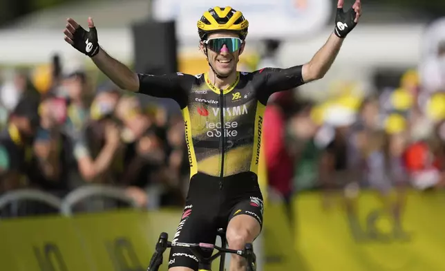 Britain's Simon Yates crosses the finish line to win the the tenth stage of the Tour de France cycling race over 165.3 kilometers (102.7 miles) with start in Ennezat and finish in Le Mont-Dore Puy de Sancy, France, Monday, July 14, 2025. (AP Photo/Mosa'ab Elshamy)