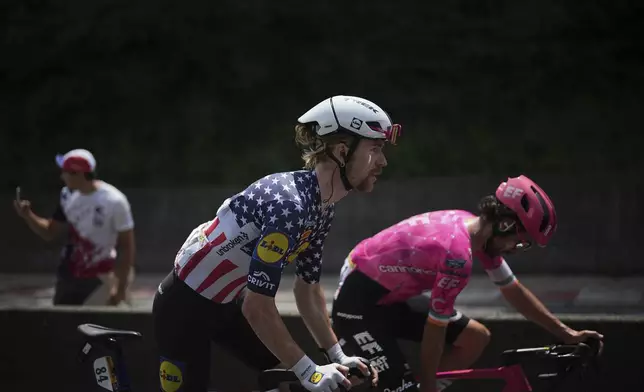 Quinn Simmons of the U.S., center, and Ireland's Ben Healy ride in the breakaway during the tenth stage of the Tour de France cycling race over 165.3 kilometers (102.7 miles) with start in Ennezat and finish in Le Mont-Dore Puy de Sancy, France, Monday, July 14, 2025. (AP Photo/Thibault Camus)