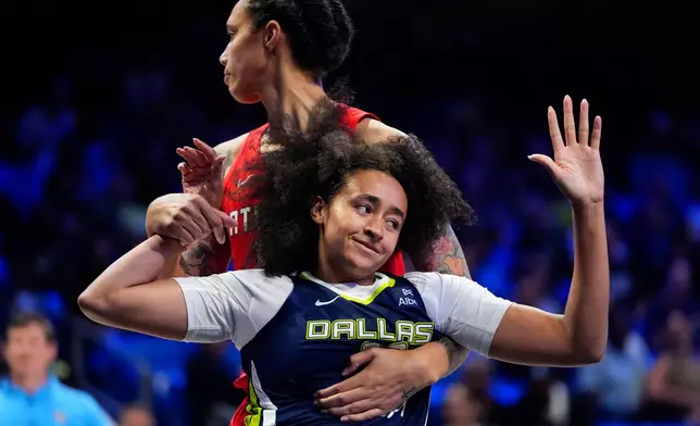 Dallas Wings guard Haley Jones, front, is fouled by Atlanta Dream center Brittney Griner (42) during the second half of a WNBA basketball game in Arlington, Texas, Wednesday, July 30, 2025. (AP Photo/LM Otero)