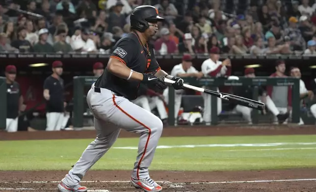 San Francisco Giants' Rafael Devers hits an RBI single against the Arizona Diamondbacks in the fifth inning during a baseball game, Wednesday, July 2, 2025, in Phoenix. (AP Photo/Rick Scuteri)