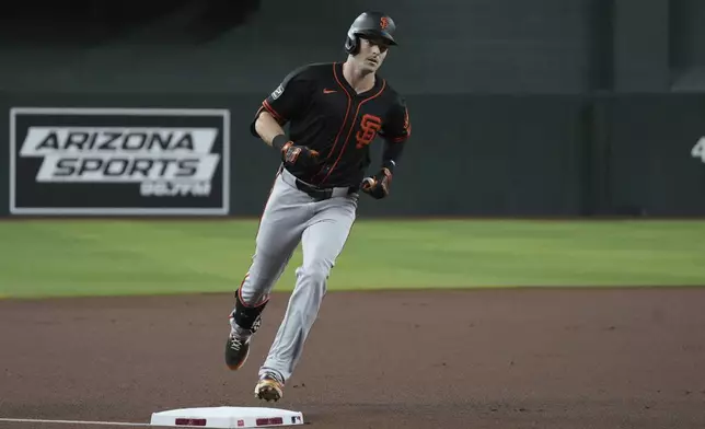 San Francisco Giants' Mike Yastrzemski circles the bases after hitting a solo home run against the Arizona Diamondbacks in the first inning during a baseball game, Wednesday, July 2, 2025, in Phoenix. (AP Photo/Rick Scuteri)