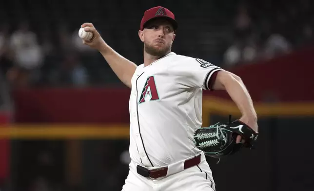 Arizona Diamondbacks pitcher Merrill Kelly throws against the San Francisco Giants in the first inning during a baseball game, Wednesday, July 2, 2025, in Phoenix. (AP Photo/Rick Scuteri)