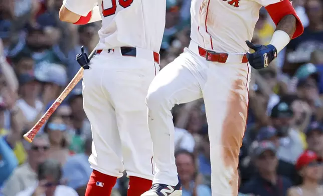 Boston Red Sox's Ceddanne Rafaela celebrates with Marcelo Mayer (39) after hitting a two run homer in the sixth inning of a baseball game, Sunday, July 13, 2025, in Boston. (AP Photo/Greg M. Cooper)