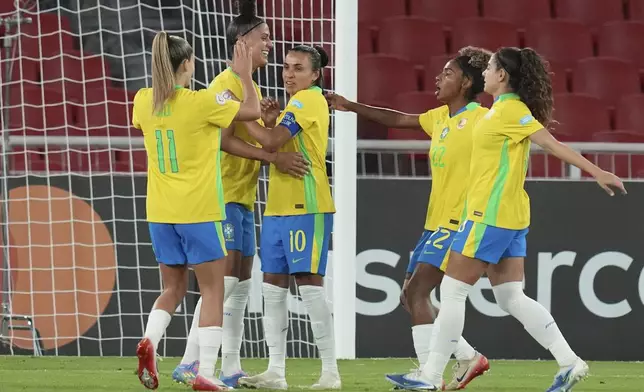 Brazil's Marta, center, celebrates with teammates after scoring her side's third goal against Uruguay, from the penalty spot, during a Women's Copa America soccer semifinal at Rodrigo Paz Delgado stadium in Quito, Ecuador, Tuesday, July 29, 2025. (AP Photo/Dolores Ochoa)