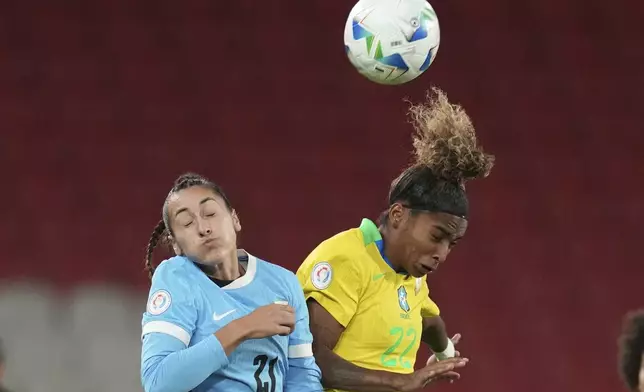 Uruguay's Juliana Viera, left, and Brazil's Luany go for a header during a Women's Copa America semifinal soccer match at Rodrigo Paz Delgado stadium in Quito, Ecuador, Tuesday, July 29, 2025. (AP Photo/Dolores Ochoa)
