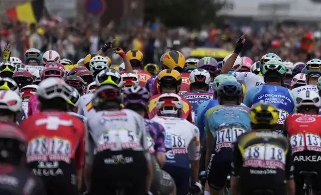 The pack rides during the first stage of the Tour de France cycling race over 184.9 kilometers (114.9 miles) with start and finish in Lille, France, Saturday, July 5, 2025. (AP Photo/Mosa'ab Elshamy)