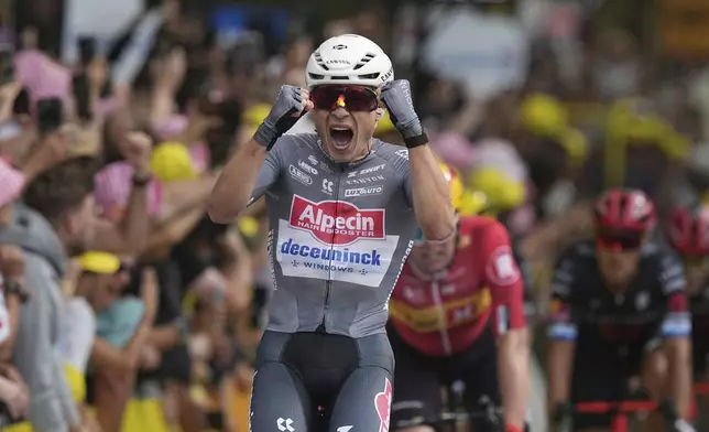 Belgium's Jasper Philipsen celebrates as he crosses the finish line to win the first stage of the Tour de France cycling race over 184.9 kilometers (114.9 miles) with start and finish in Lille, France, Saturday, July 5, 2025. (AP Photo/Thibault Camus)