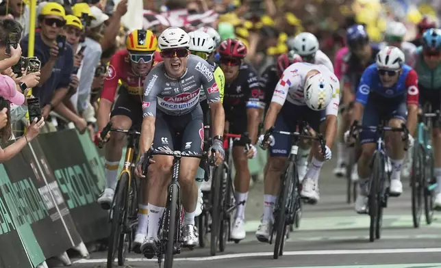 Belgium's Jasper Philipsen celebrates as he crosses the finish line to win the first stage of the Tour de France cycling race over 184.9 kilometers (114.9 miles) with start and finish in Lille, France, Saturday, July 5, 2025. (AP Photo/Thibault Camus)