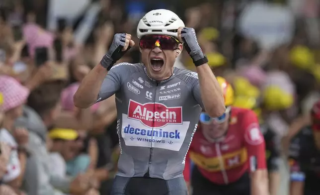 Belgium's Jasper Philipsen celebrates as he crosses the finish line to win the first stage of the Tour de France cycling race over 184.9 kilometers (114.9 miles) with start and finish in Lille, France, Saturday, July 5, 2025. (AP Photo/Thibault Camus)