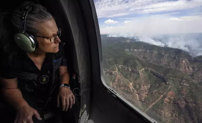 Arizona Gov. Katie Hobbs looks out of a helicopter window during her aerial tour of wildfire damage along the Grand Canyon's North Rim, Ariz., Saturday, July 19, 2025. (Joe Rondone/The Arizona Republic via AP, Pool)