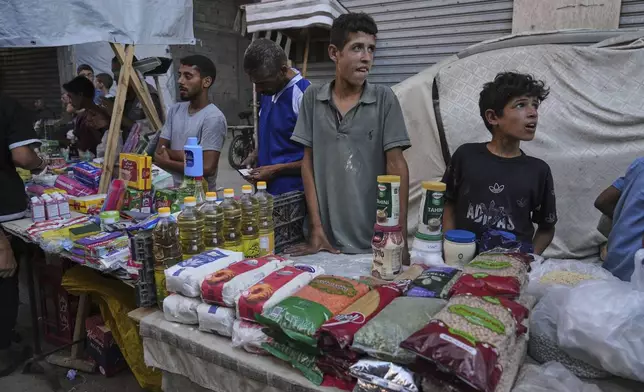Palestinian vendors display goods for sale at a street market in Gaza City, Wednesday, July 23, 2025. (AP Photo/Jehad Alshrafi)
