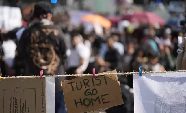 A protest sign is displayed on a makeshift clothesline during a demonstration against gentrification, as the increase in remote workers has risen prices and increased housing demand in neighborhoods like Condesa and Roma, in Mexico City, Friday, July 4, 2025. (AP Photo/Fernando Llano)