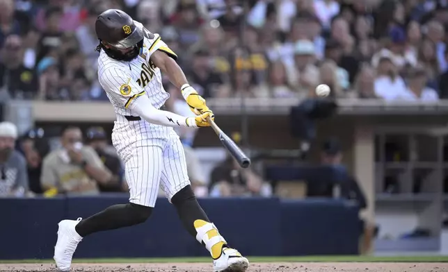 San Diego Padres' Fernando Tatis Jr. hits a home run during the third inning of a baseball game against the Arizona Diamondbacks, Thursday, July 10, 2025, in San Diego. (AP Photo/Orlando Ramirez)