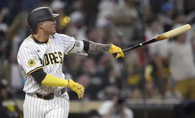 San Diego Padres' Manny Machado hits a home run during the fifth inning of a baseball game against the Arizona Diamondbacks, Thursday, July 10, 2025, in San Diego. (AP Photo/Orlando Ramirez)