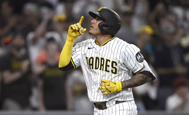 San Diego Padres' Manny Machado celebrates after hitting a home run during the fifth inning of a baseball game against the Arizona Diamondbacks, Thursday, July 10, 2025, in San Diego. (AP Photo/Orlando Ramirez)