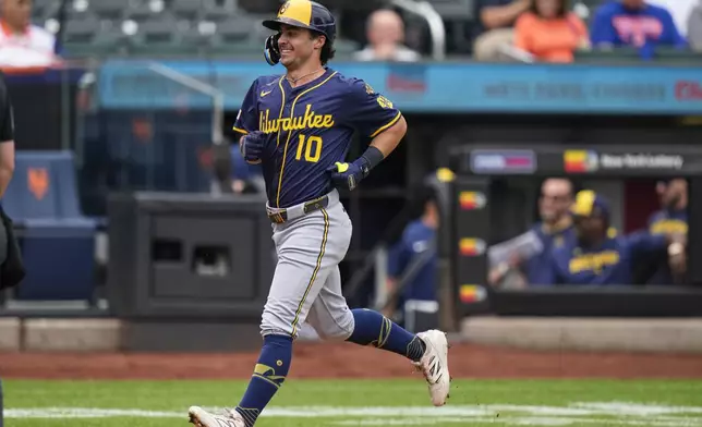 Milwaukee Brewers' Sal Frelick smiles as he approaches home plate after hitting a home run during the first inning in the first baseball game of a doubleheader against the New York Mets, Wednesday, July 2, 2025, in New York. (AP Photo/Frank Franklin II)