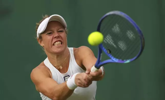 Laura Siegemund of Germany returns the ball to Solana Sierra of Argentina during their women's singles fourth round match at the Wimbledon Tennis Championships in London, Sunday, July 6, 2025.(AP Photo/Kirsty Wigglesworth)