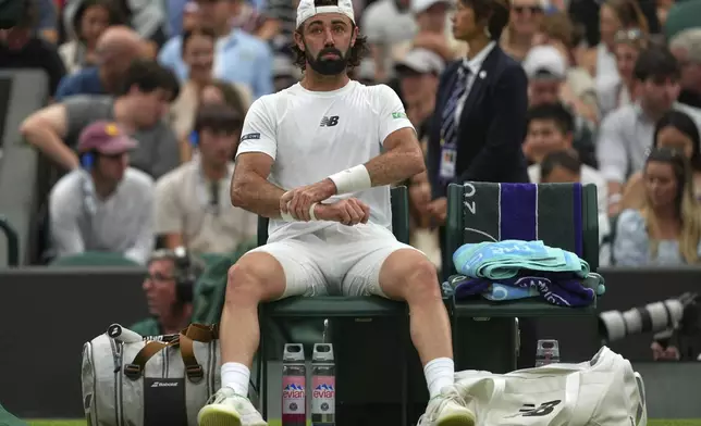 Jordan Thompson of Australia rests on his chair during his men's singles fourth round match against Taylor Fritz of the U.S. at the Wimbledon Tennis Championships in London, Sunday, July 6, 2025.(AP Photo/Joanna Chan)