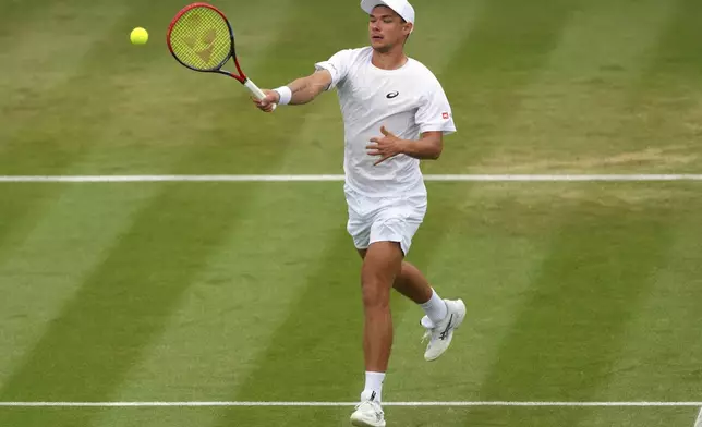 Kamil Majchrzak of Poland plays a return to Karen Khachanov of Russia during their men's singles fourth round match at the Wimbledon Tennis Championships in London, Sunday, July 6, 2025.(AP Photo/Kirsty Wigglesworth)