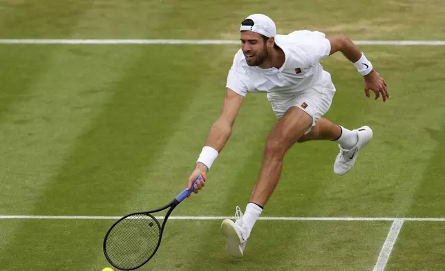 Karen Khachanov of Russia plays a return to Kamil Majchrzak of Poland during their men's singles fourth round match at the Wimbledon Tennis Championships in London, Sunday, July 6, 2025.(AP Photo/Kirsty Wigglesworth)