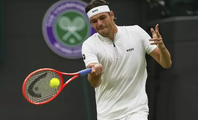 Taylor Fritz of the U.S. plays a return to Jordan Thompson of Australia during their men's singles fourth round match at the Wimbledon Tennis Championships in London, Sunday, July 6, 2025.(AP Photo/Joanna Chan)