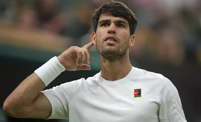 Spain's Carlos Alcaraz gestures as he plays Russia's Andrey Rublev during a fourth round men's singles match at the Wimbledon Tennis Championships in London, Sunday, July 6, 2025. (AP Photo/Alastair Grant)