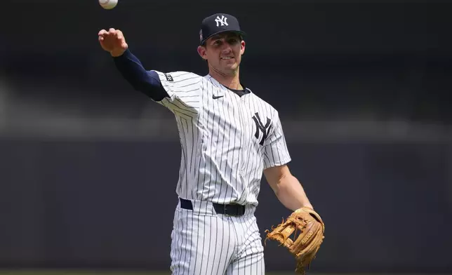 New York Yankees third baseman Ryan McMahon (19) warms up before a baseball game against the Philadelphia Phillies, Saturday, July 26, 2025, in New York. (AP Photo/Yuki Iwamura)