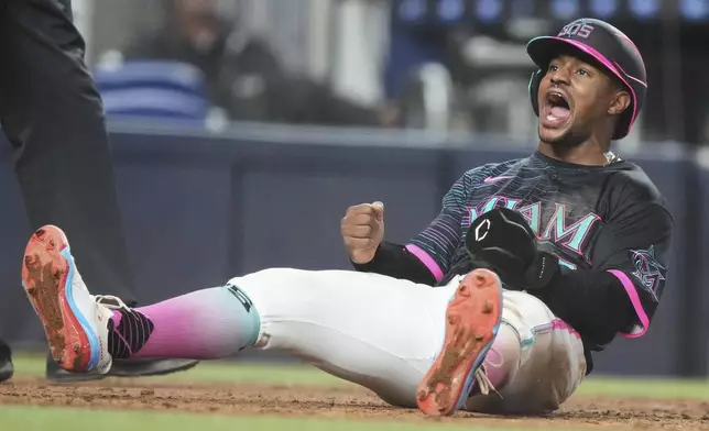 Miami Marlins' Xavier Edwards reacts after scoring on a single hit by Agustin Ramirez during the eighth inning of a baseball game against the Milwaukee Brewers, Saturday, July 5, 2025, in Miami. (AP Photo/Lynne Sladky)
