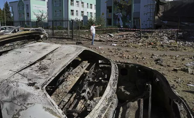 Damaged cars lie in a yard among other debris after a Russian drone and missile attacks in Kyiv, Ukraine, Friday, July 4, 2025. (AP Photo/Efrem Lukatsky)