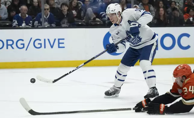 FILE - Toronto Maple Leafs right wing Mitch Marner (16) shoots past Anaheim Ducks defenseman Pavel Mintyukov (34) during the second period of an NHL hockey game, March 30, 2025, in Anaheim, Calif. (AP Photo/Kyusung Gong, file)