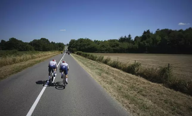France's Matteo Vercher, left, and France's Mathieu Burgaudeau, right, ride breakaway during the eighth stage of the Tour de France cycling race over 171.4 kilometers (106.5 miles) with start in Saint-Meen-le-Grand and finish in Laval Espace Mayenne, France, Saturday, July 12, 2025. (AP Photo/Thibault Camus)
